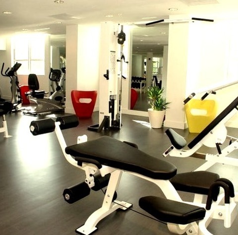 Miami Weight Room GymLarge, Modern Image Of A Home Gym With A Vinyl Floor And White Walls