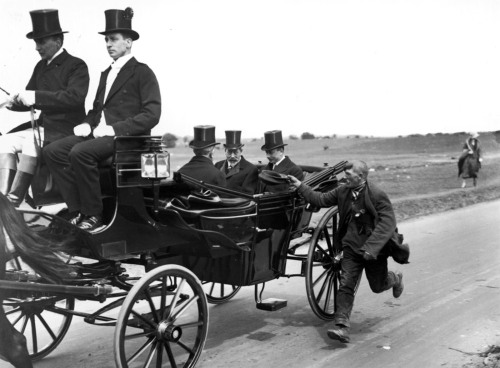 A beggar runs along King GeorgeV&rsquo;s carriage (1920).George V and his son PrinceHenry, Duke of G
