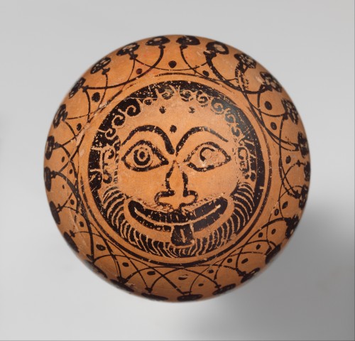 A Gorgoneion (Gorgon’s head/head of Medusa).  Tondo on the bottom of an Attic black-figure alabastro