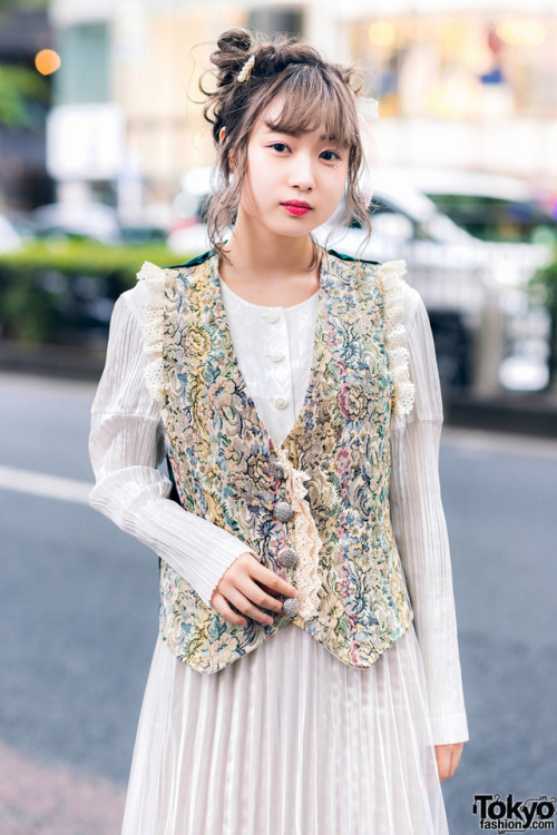 tokyo-fashion:  20-year-old Japanese student Mami on the street in Harajuku wearing a vintage pleated dress under a vintage floral brocade vest, and vintage silver bow-laced shoes. Full Look