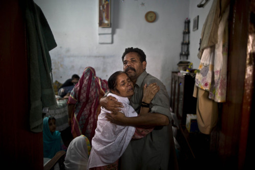 Anwar Waseem, 53, and his sister Sakinah, 58, comfort each other as they mourn the death of her daug