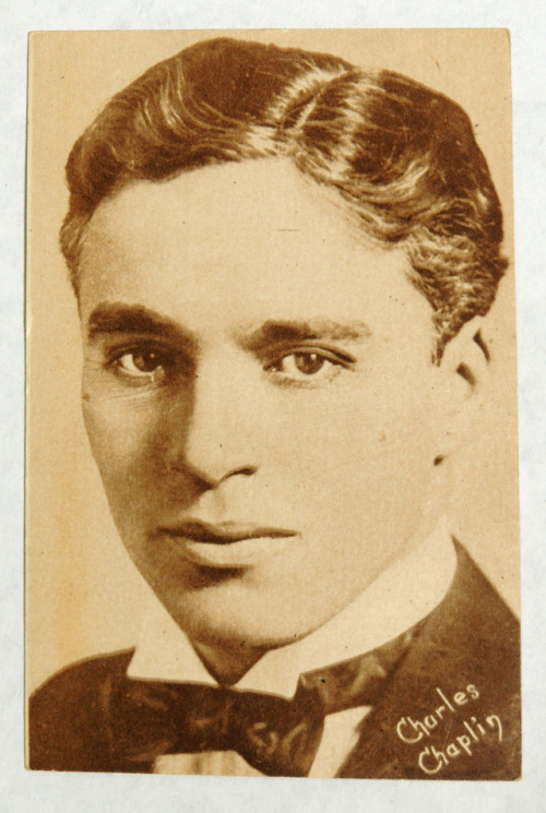 An antique arcade photo card of the great Charlie Chaplin out of his Tramp costume/makeup (circa 191