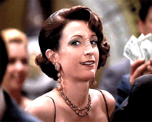 garlandsjudys: [Start ID: Two gifs of Kira Nerys on Deep Space 9 undercover at Vic’s casino. She smi