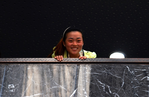 Cute Chinese girl looking over the balcony of the 2nd floor in the National Museum of Chinese Writin