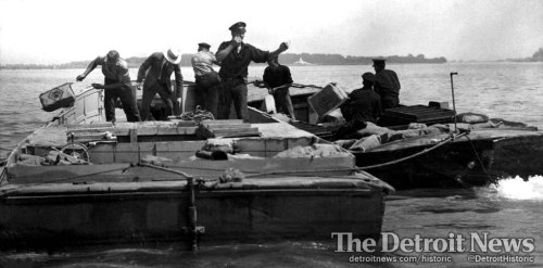 The Coast Guard dumps bootleg beer into the Detroit River during a Prohibition-era bust. More histor