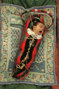 vintagenatgeographic:  Native American baby in a cradle board at the annual powwow in White Swan, Washington National Geographic | June 1994 