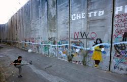 unrar:    A Palestinian boy kicks a ball