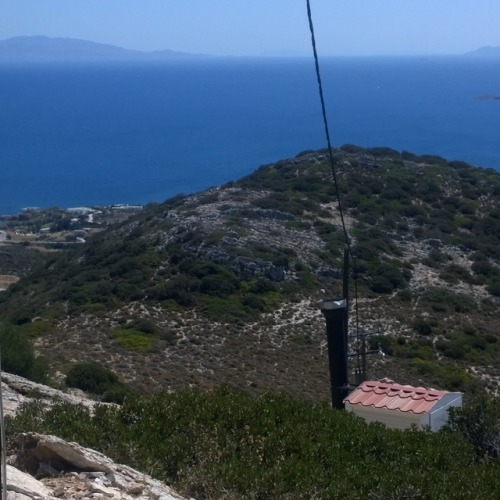 What appears to be an acropolis (upper city) on Antiparos (to the left of the modern wire) above the