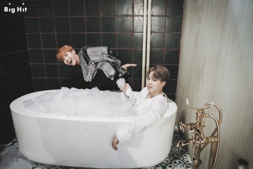 two bros chillin in the hot tub, two feet apart cause they’re not gay