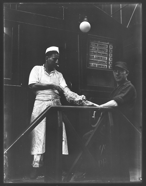 Short Order Cook and Worker Playing Tug-of-War with Raw Meat Outside Lunchroom Doorway on Second Ave