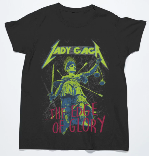 popgonemetal:      At any point, it feels as if Gaga will ride into the sunset with a flaming skull in one hand and liberty of justice in the other. Never fear Queen Gaga is here to solve all of your problems, with the looks of these tee’s she’ll