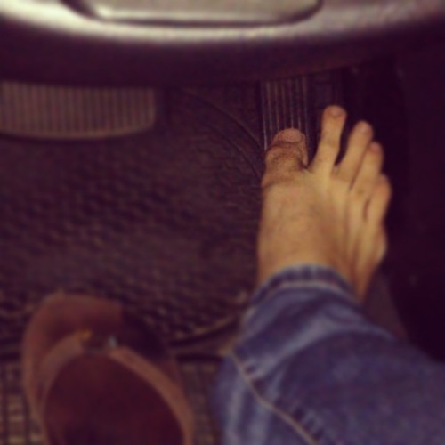He likes airing out his ripe feet from his sweat-baked flip flops while driving