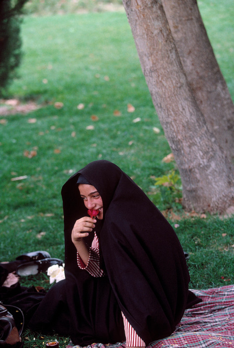 hopeful-melancholy:   A young woman with a rose in the Chahar Bagh gardens. Iran, 1998. A.Abbas