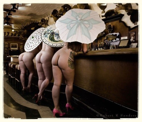memoryanddesire-stirring:  Belly up!! :)  Awesome, fun picture with three delicious looking backsides :)  Love the umbrellas - adds that “I want to see more” vibe!