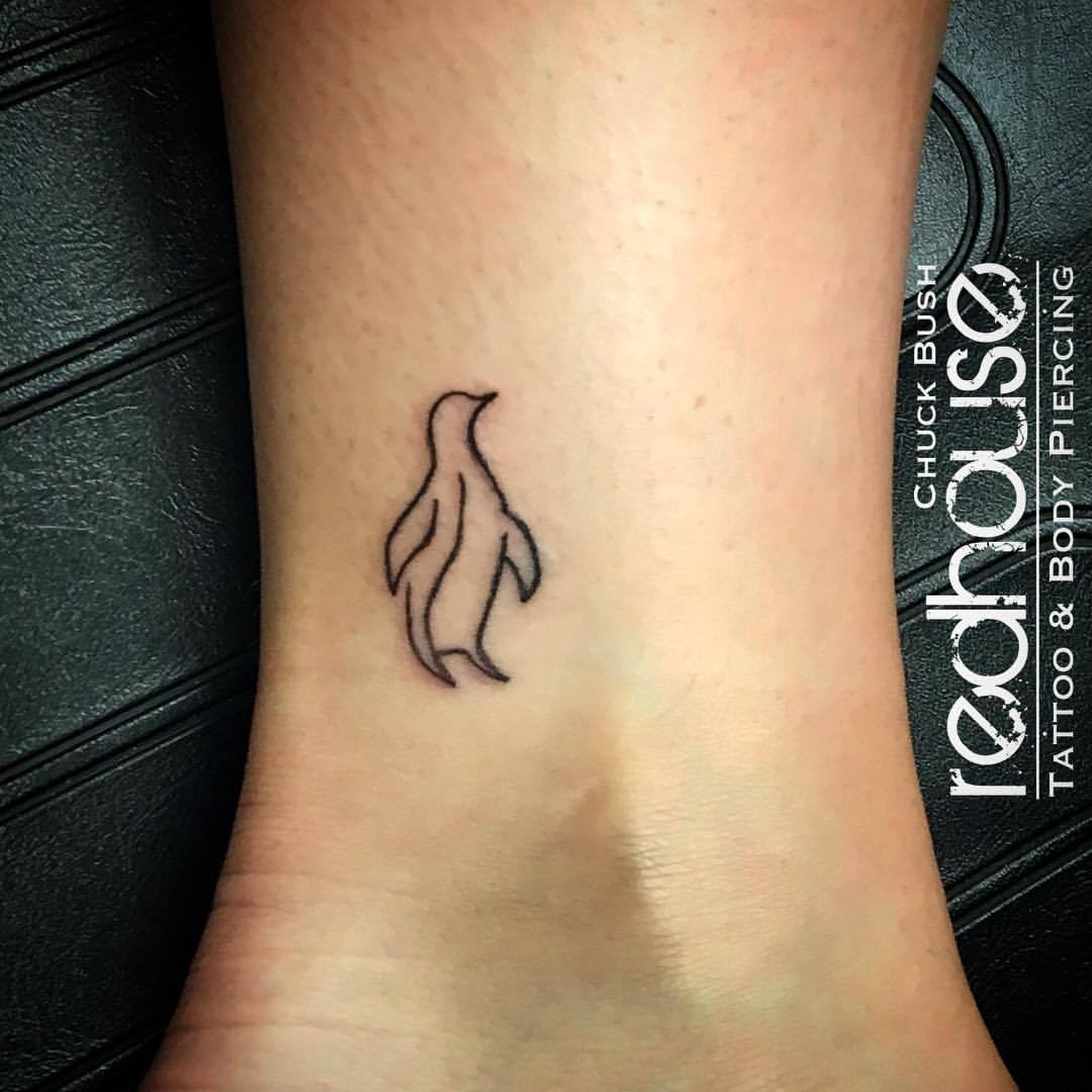 Tiny penguin tattoo on ankle