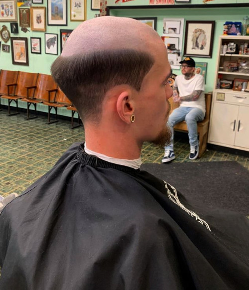 hairfucker:An immaculately styled male-pattern baldness haircut delivered in a public barbershop.