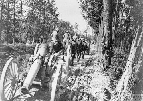 A French horse-drawn battery of 155 mm short artillery guns going up to forward positions between Ec