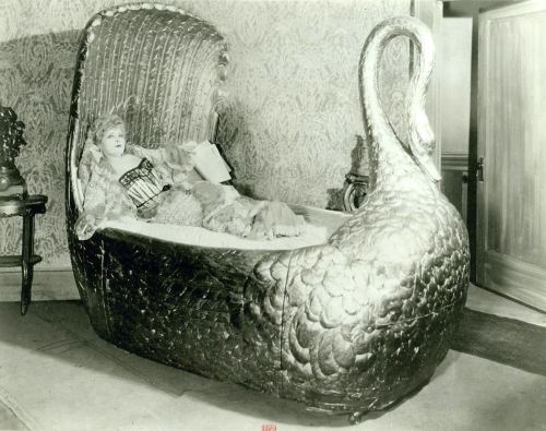 girl-o-matic:  Mae West lying down in a golden swan bed in the film Diamond Lil’