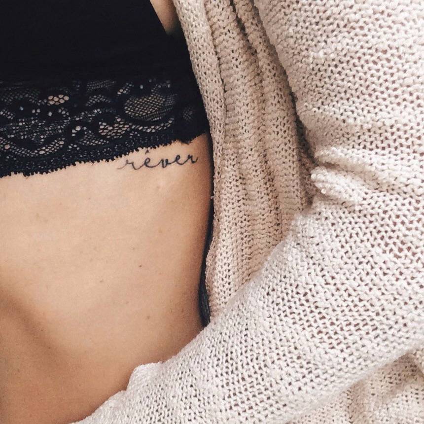 Rib tattoo saying “Rêver”, French for “to dream.” Tattoo artist: Brenda Gabriella