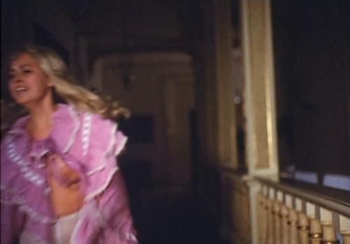 chickswithcandles:Lina Romay as a Gothic gaslit dame running through a dark hallway.