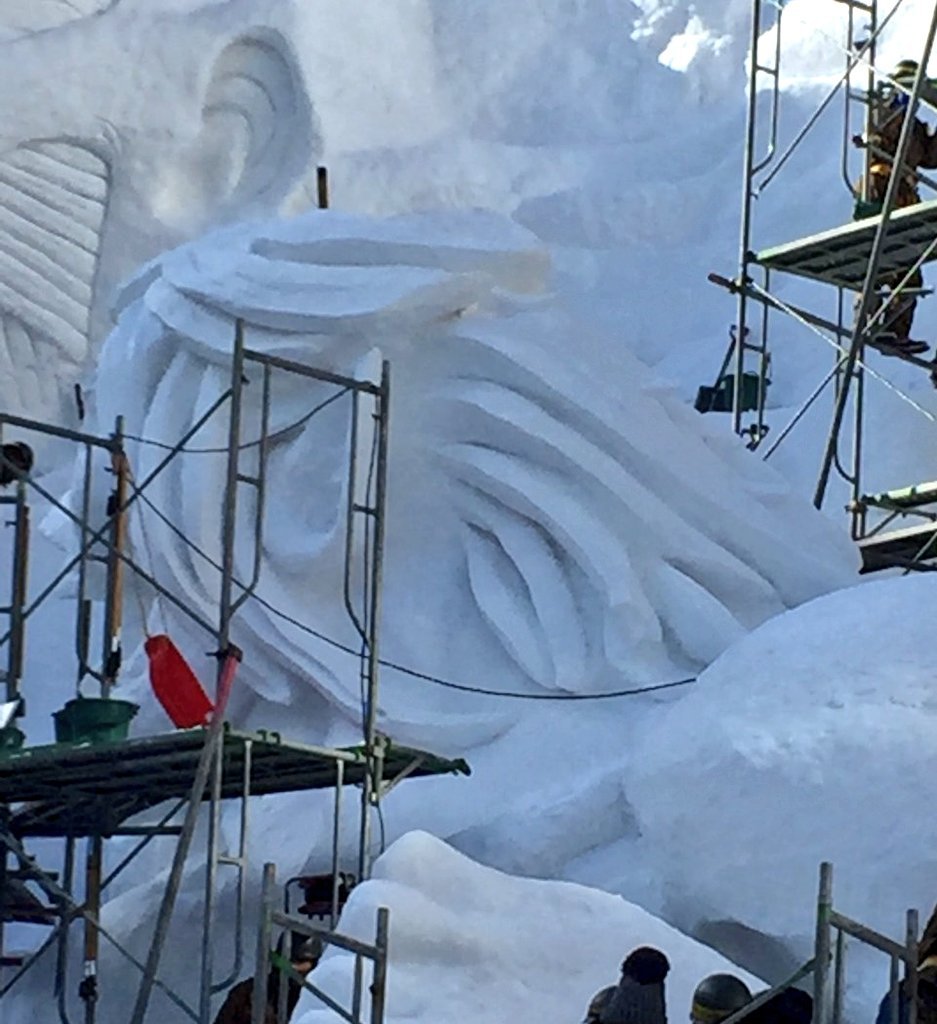 Close-ups of the Colossal Titan model and actual snow sculpture under construction,