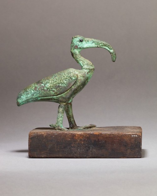 Ancient Egyptian statuette of an ibis (cupreous metal with glass or stone inlay, on a wooden base). 