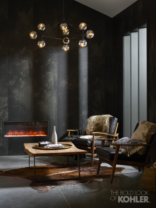 A modern gas fireplace and a playful mobile bring light to a stunning black space.