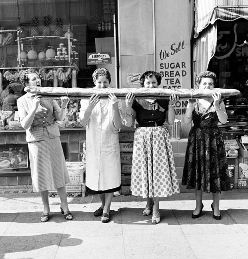 vintageeveryday:Four women sharing a 9 foot long baguette in Soho, circa 1955.