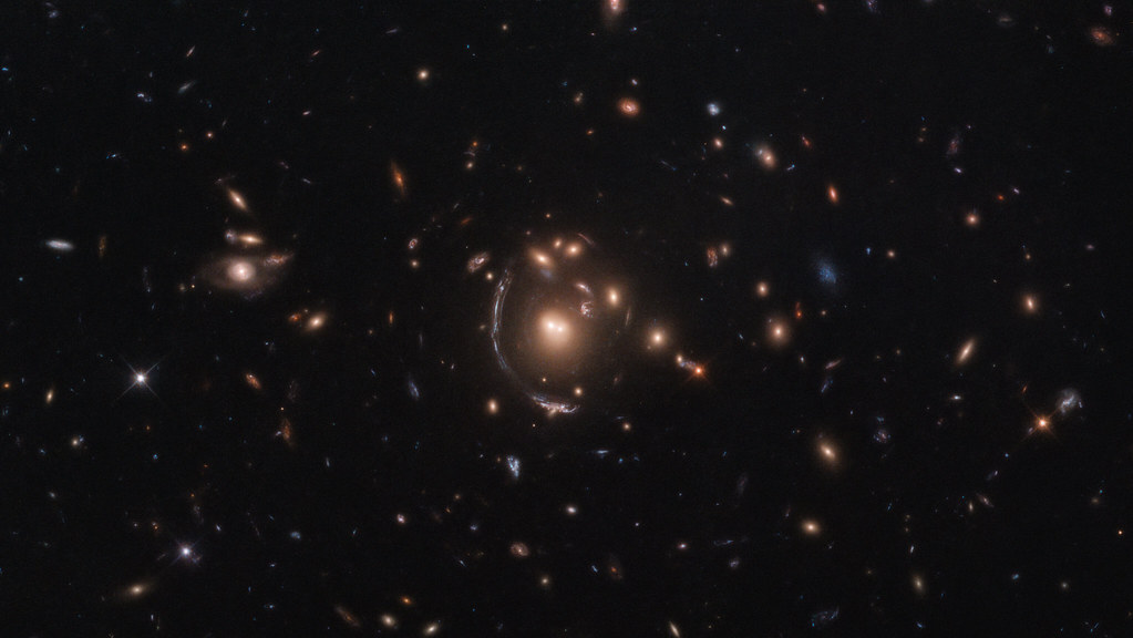 Hubble Spies Galaxy through Cosmic Lens by NASA Hubble