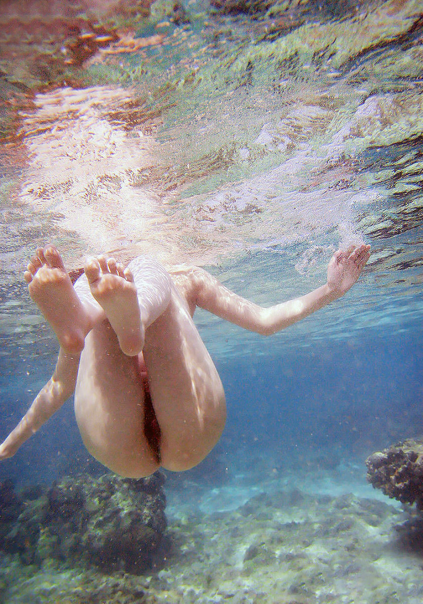 Naked girl underwater swimming pool