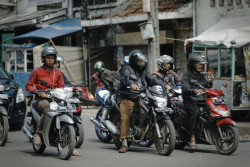 Man rides motorcycle. Bandung, Indonesia