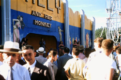 Vintage 50’S-Era Candid Photo Captures Crowds Ambling Past A Carnival Barker, While