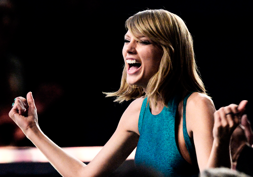 : Taylor Swift cheers from the audience at the 2015 Grammy Awards