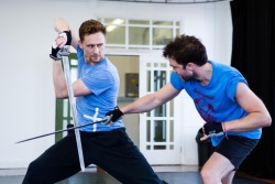 art-of-swords:  Tom Hiddleston wielding a sword is pretty much one of the hottest things ever Disclaimer: especially for Tom’s fans! Check out these behind-the-scenes shots from rehearsals with Coriolanus costar Hadley Fraser.  Source: Images &amp;