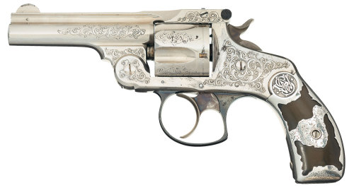 Engraved Smith and Wesso double action revolver with trimmed Tiffany style silver grips. Featured in