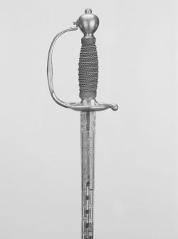 art-of-swords:  Dress Sword Dated: 1700-50 Culture: German Medium: gilt brass, wood, wire, blued steel, gilt Measurements: overall length 100.5 cm; blade length 85 cm The sword has a gilt bronze hilt with a feather edged knuckle guard, a barrel-shaped