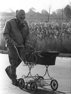 historicaltimes:  A cleanup liquidator, pushes a baby in a carriage
