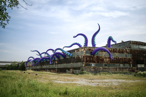 escapekit:  Sea Monsters HERE UK-based artists Filthy Luker and Pedro Estrellas have created twenty inflatable tentacles extended from the roof and several windows of a two-story warehouse in Philadelphia’s Navy Yard. The purple tentacles range from