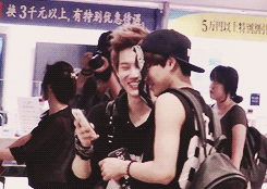 jongins:  suho messing around with kai’s bandana and taking photos of him 