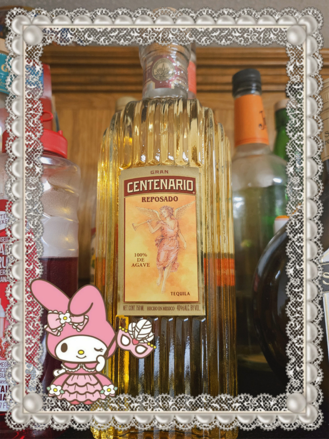 bottle of centenario reposado tequila. it is pretty and regal, with an angel on the label