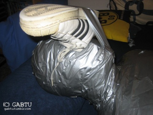 gabtu:I thought it would be a good idea to give him something to sniff on while he enjoyed his mummification. When I needed my hands to do something else I taped that sneaker over his nose.