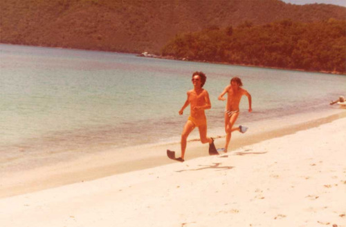 [click to enlarge]George Harrison and Eric Idle racing on the beach in flippers while on holiday in 