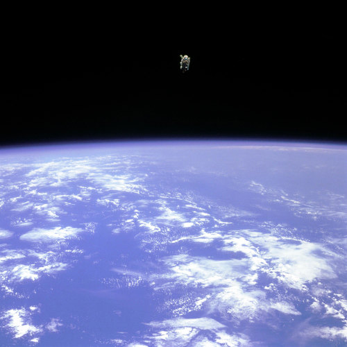 katjohnadams: Bruce McCandless II, floating in orbit far from the Space Shuttle, unsecured by tether