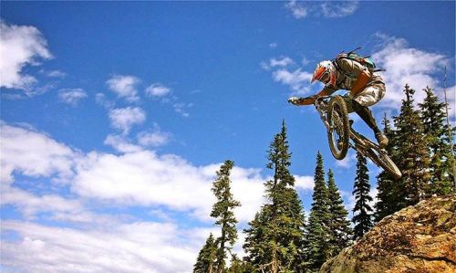 Wade Simmons boosts off a rocky outcropping in Whistler Bike Park . #mountainbikes #mountainbike #MT