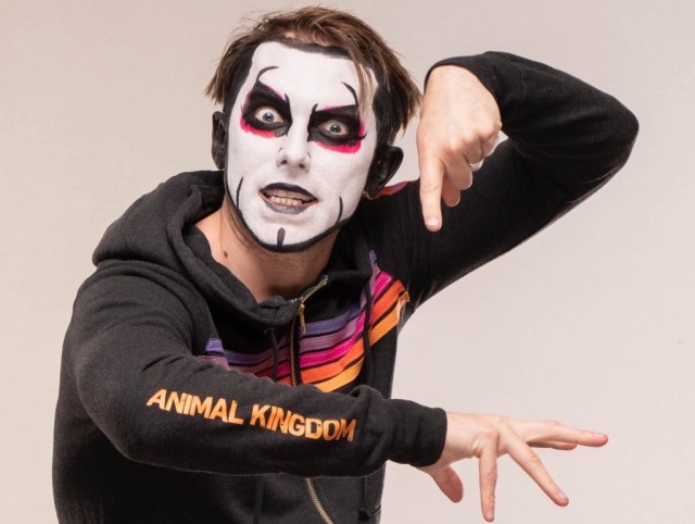 danhausen in an animal kingdom hoodie pointing to the logo with wide eyes