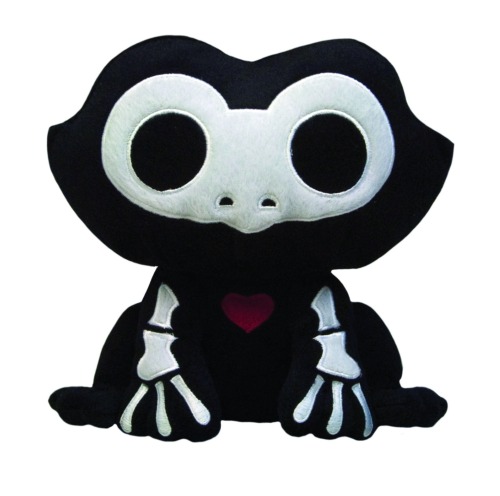 A stuffed animal of a black frog with a white skeleton. The bones are cartoony and simple. There is a small red heart in the middle of its chest.