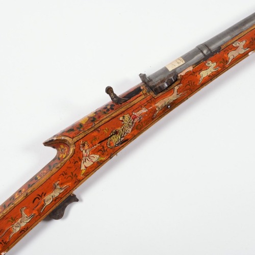 Orange lacquered matchlock toradar musket originating from India, 19th century.from Millea Bros. LTD