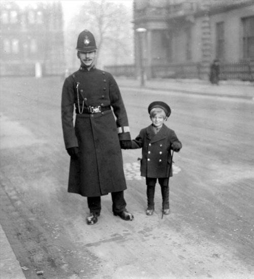 Policeman and young boy, London 1926