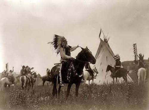 Dakota Sioux wearing war bonnet, 1907 by Edward S. Curtis.