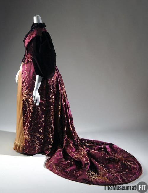 Evening dress, c. 1894Magenta floral brocade with plum velvet, yellow silk satinDelicate branches of